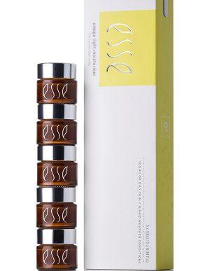 A stack of five small brown jars with silver lids labeled "esse" stands next to a tall white and yellow box featuring the "esse" branding and the product name "Omega Rich Moisturiser.