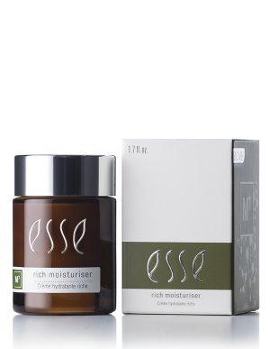 A brown glass jar of Rich Moisturiser sits beside its white and green box, both labeled with product details. The jar contains 1.7 fl. oz. of moisturiser.