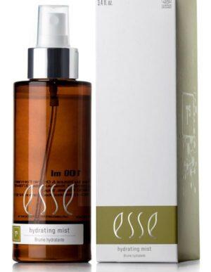 A brown spray bottle labeled "Hydrating Mist" stands beside its white and olive green box, both featuring matching branding. The bottle has a white pump, and the box lists the product volume as 3.4 fl oz.