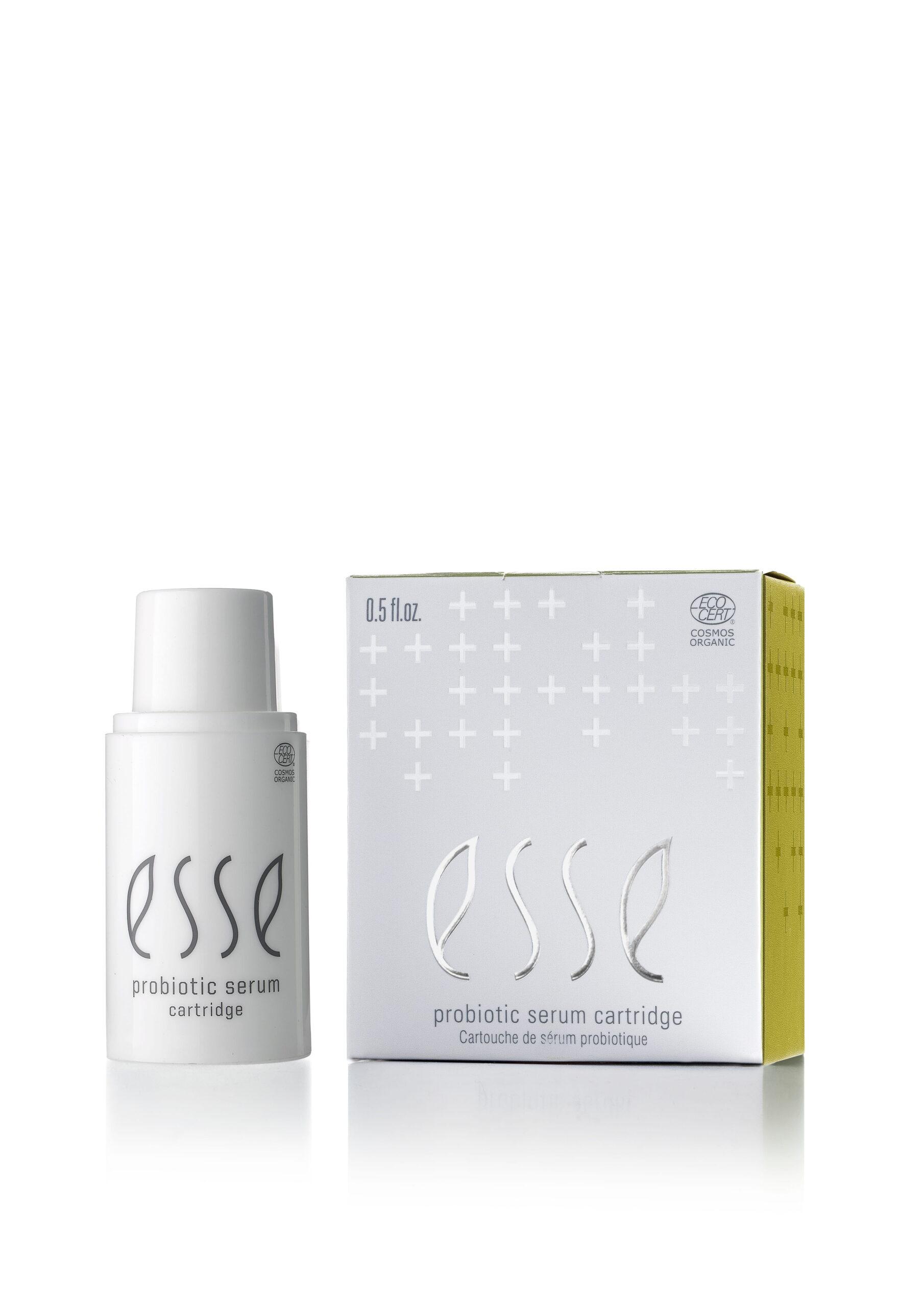 A white bottle labeled "Esse Probiotic Serum" stands beside its matching box, which is white with silver text, plus signs, and a yellow side panel.